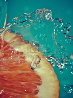 Sfondi Orange Slice In Water Drops 240x320