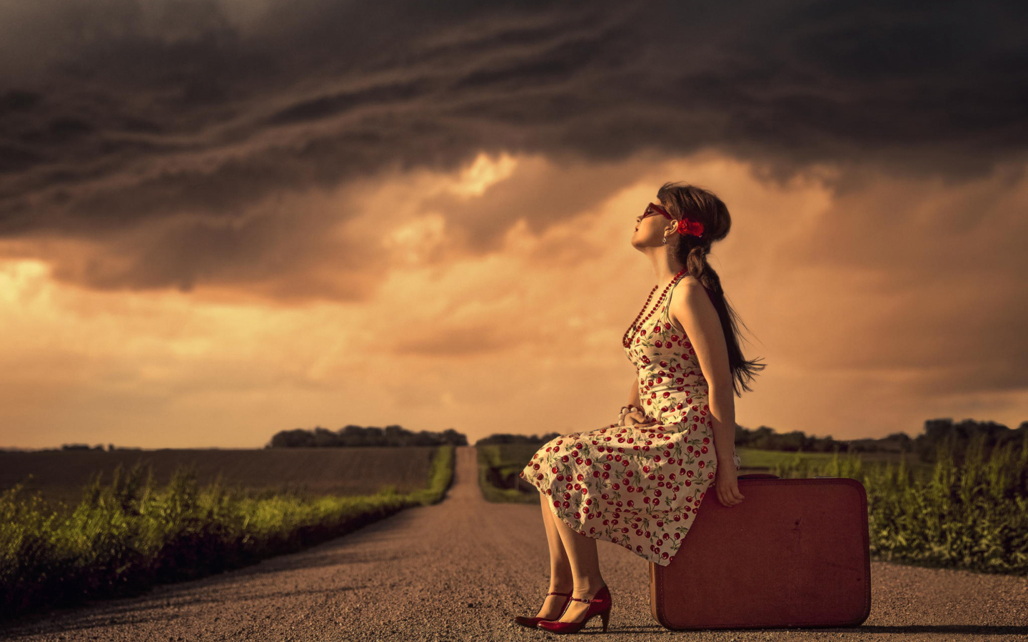 Girl Sitting On Luggage On Road wallpaper 1440x900