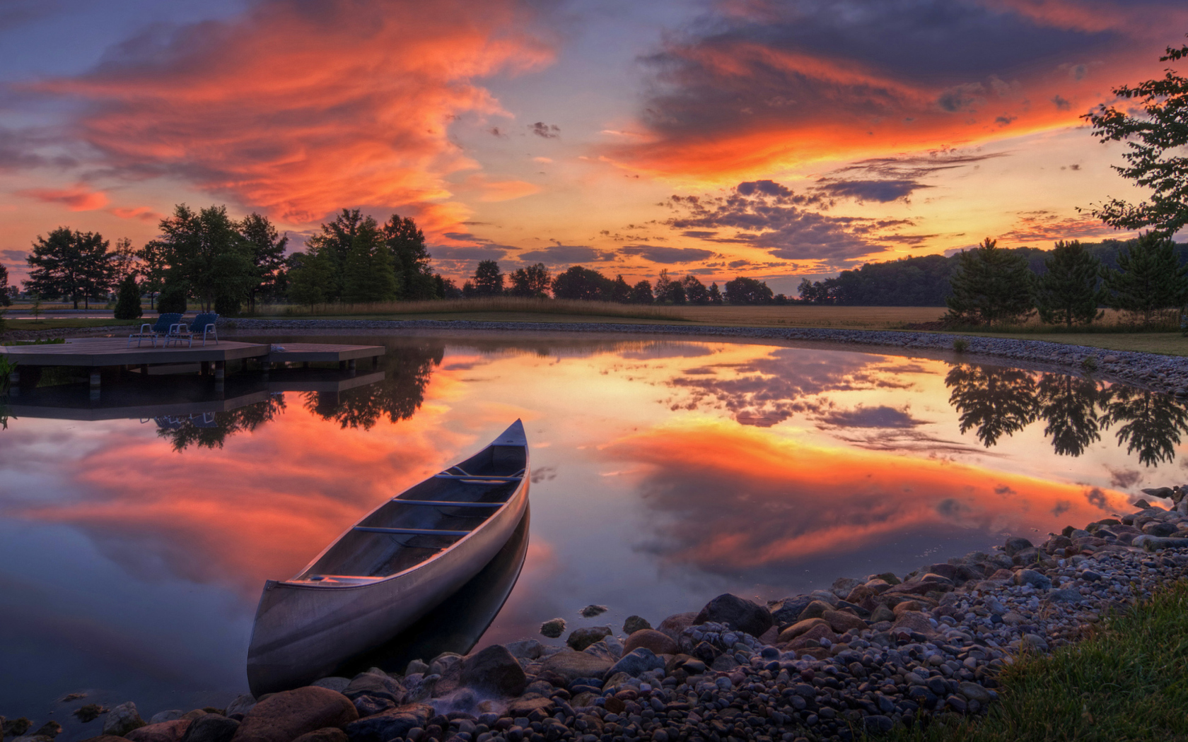 Fondo de pantalla Canoe At Sunset 1680x1050