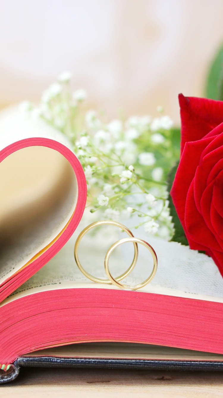 Wedding rings and book wallpaper 750x1334