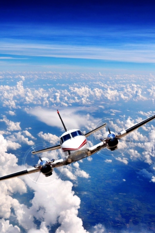 Plane Over The Clouds wallpaper 320x480