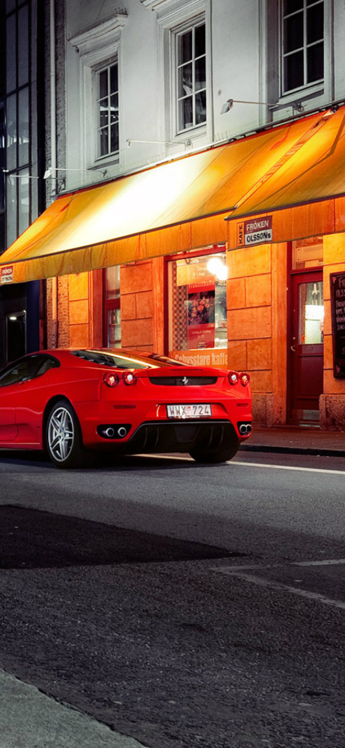 Red Ferrari In City Lights wallpaper 1170x2532