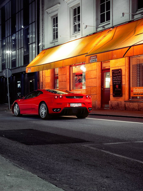 Das Red Ferrari In City Lights Wallpaper 480x640