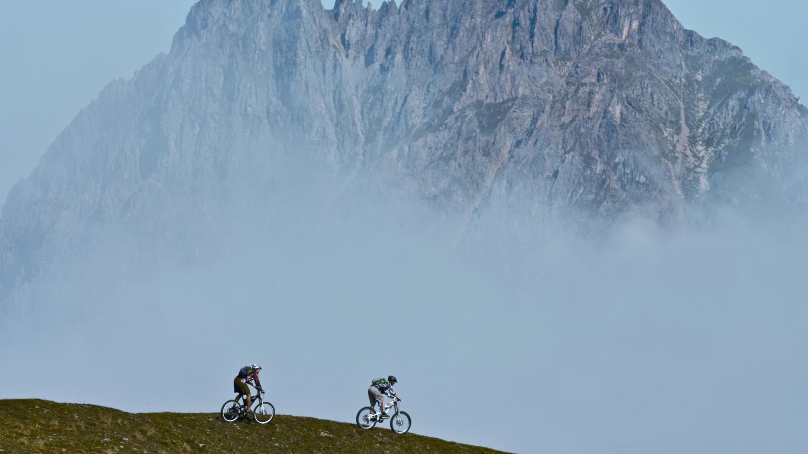 Обои Bicycle Riding In Alps Mountains 1600x900