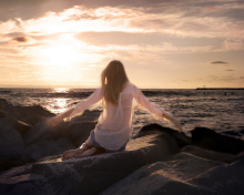 Girl Sitting On Stones On Sea Coast screenshot #1 220x176