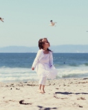 Little Girl And Seagulls On Beach wallpaper 128x160