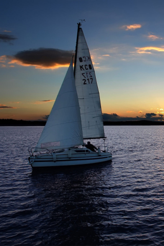 Обои Sailboat At Sunset 320x480
