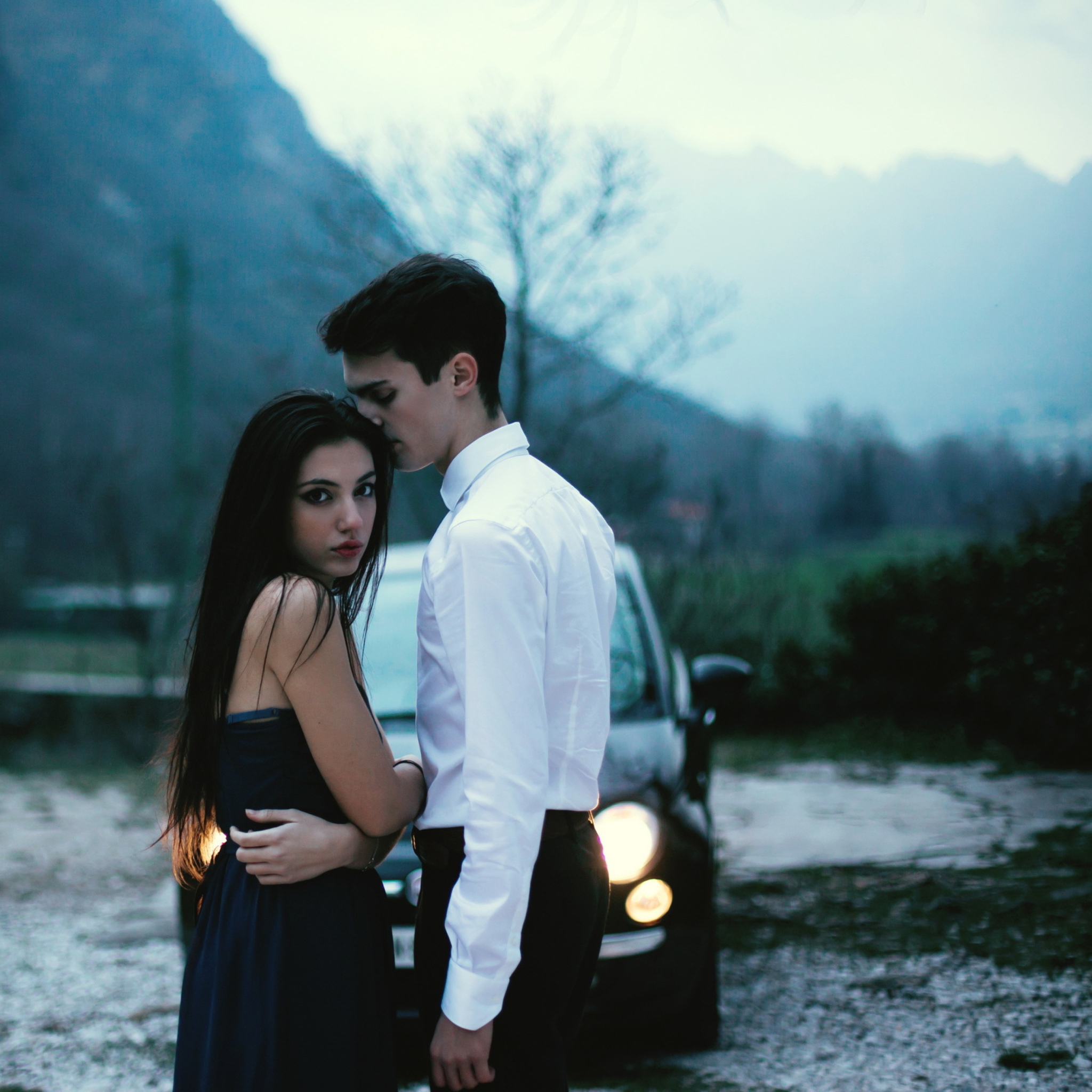 Das Couple In Front Of Car Wallpaper 2048x2048