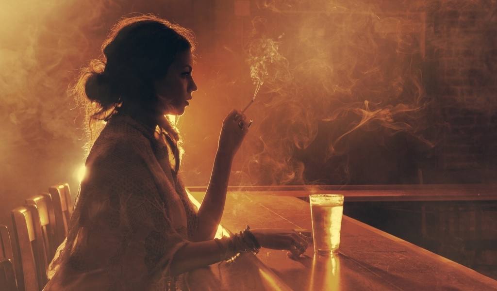 Sad girl with cigarette in bar wallpaper 1024x600