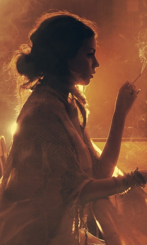 Sad girl with cigarette in bar wallpaper 480x800
