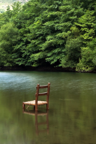 Chair In Middle Of Pieceful Lake wallpaper 320x480