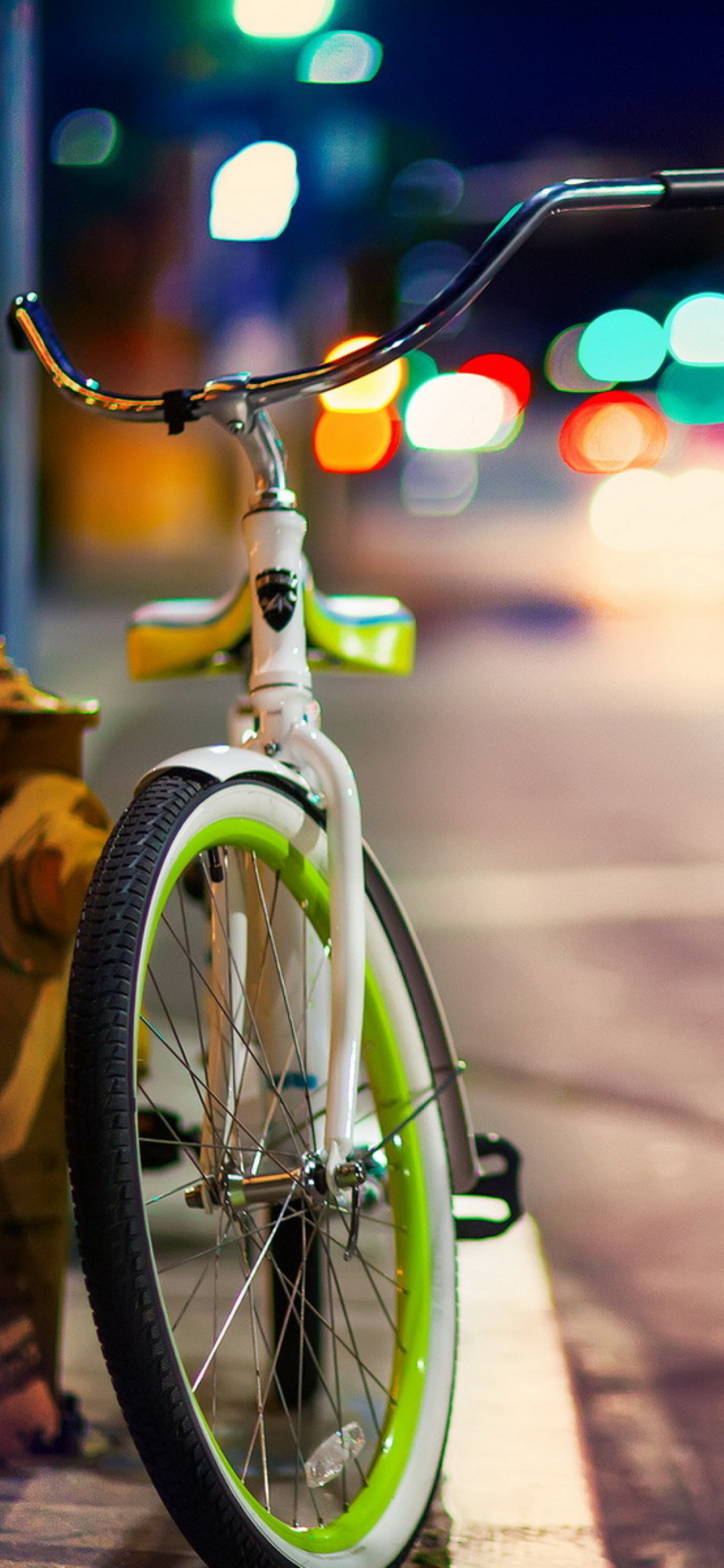 Green Bicycle In City Lights wallpaper 1170x2532
