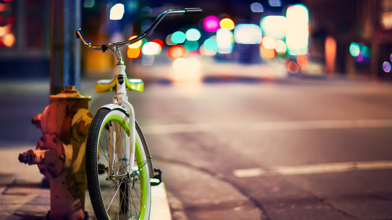 Green Bicycle In City Lights wallpaper 1366x768