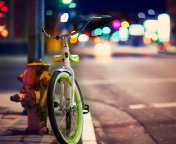 Green Bicycle In City Lights wallpaper 176x144