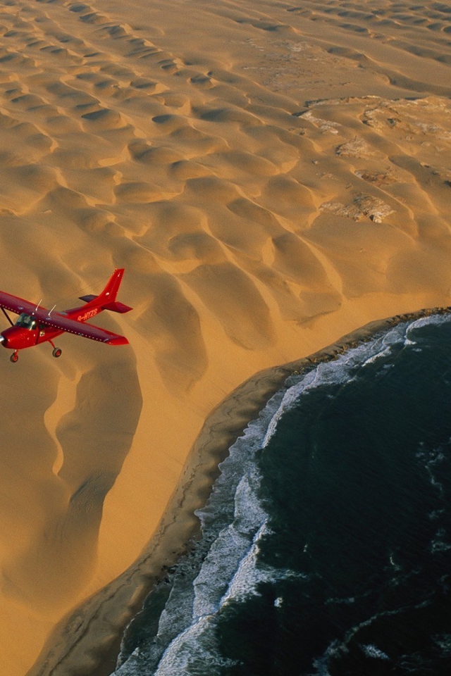 Airplane Above Desert wallpaper 640x960