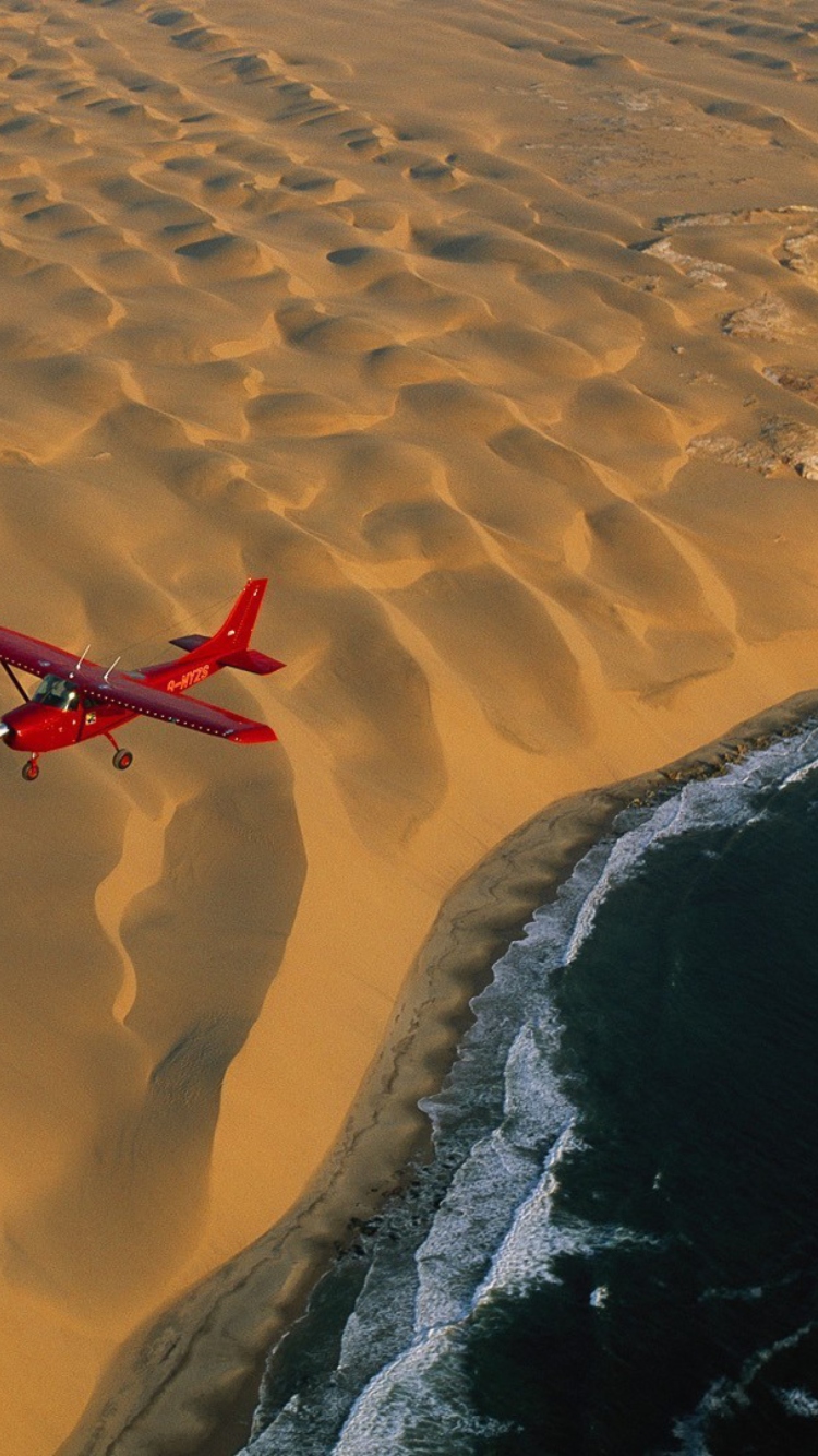 Sfondi Airplane Above Desert 750x1334