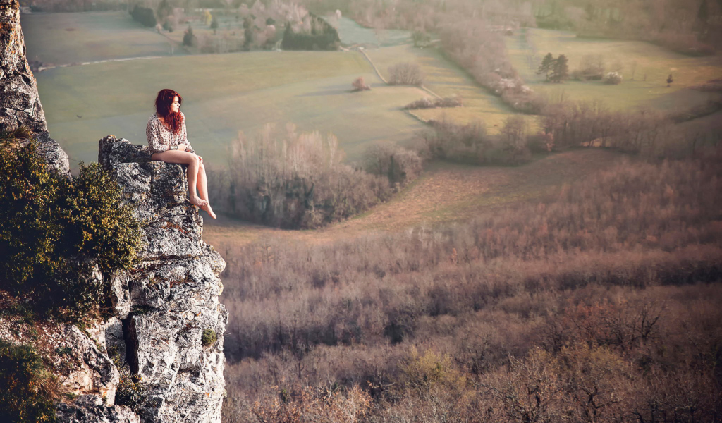 Sfondi Redhead Girl Sitting On Rock 1024x600