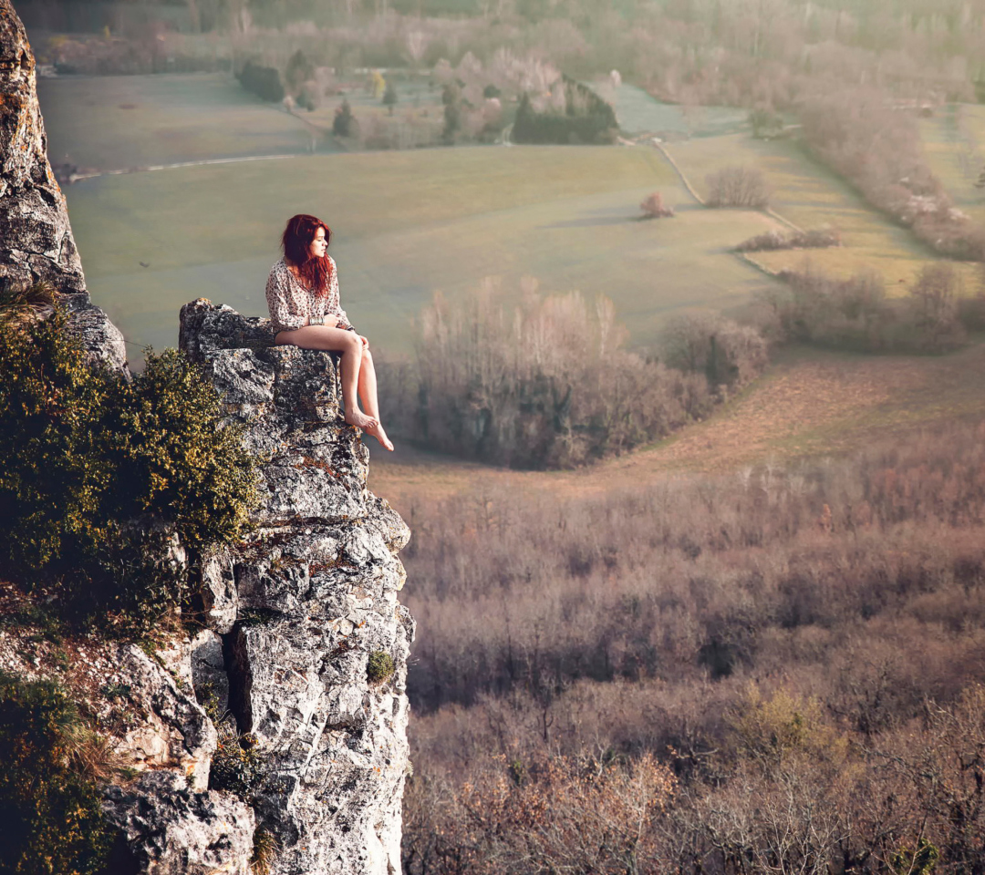 Обои Redhead Girl Sitting On Rock 1080x960