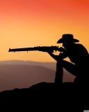 Cowboy Shooting In The Sunset wallpaper 128x160