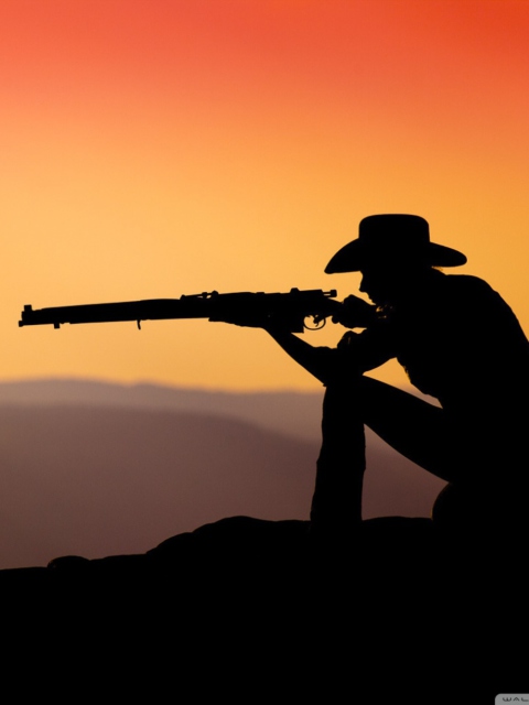 Cowboy Shooting In The Sunset wallpaper 480x640
