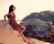 Brunette Girl Posing On Rocks screenshot #1 176x144