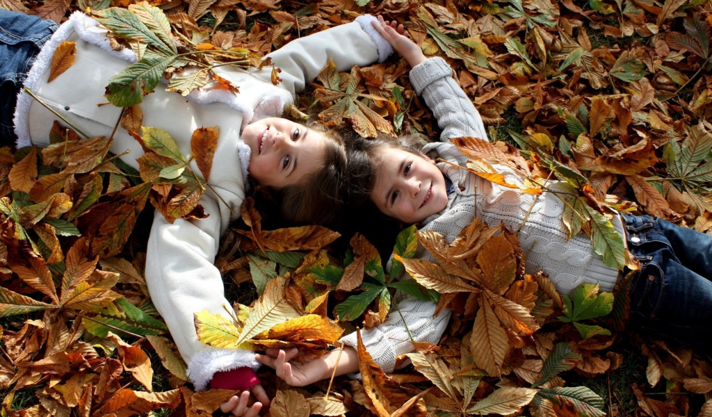 Cute Child Girls On Autumn Leaves Carpet wallpaper 1024x600
