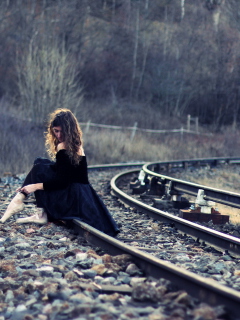 Sfondi Girl In Black Dress Sitting On Railways 240x320