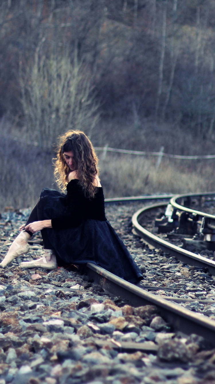 Girl In Black Dress Sitting On Railways wallpaper 750x1334