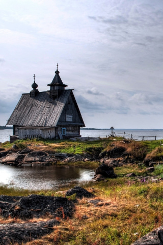Old small house on the rocky river shore screenshot #1 320x480