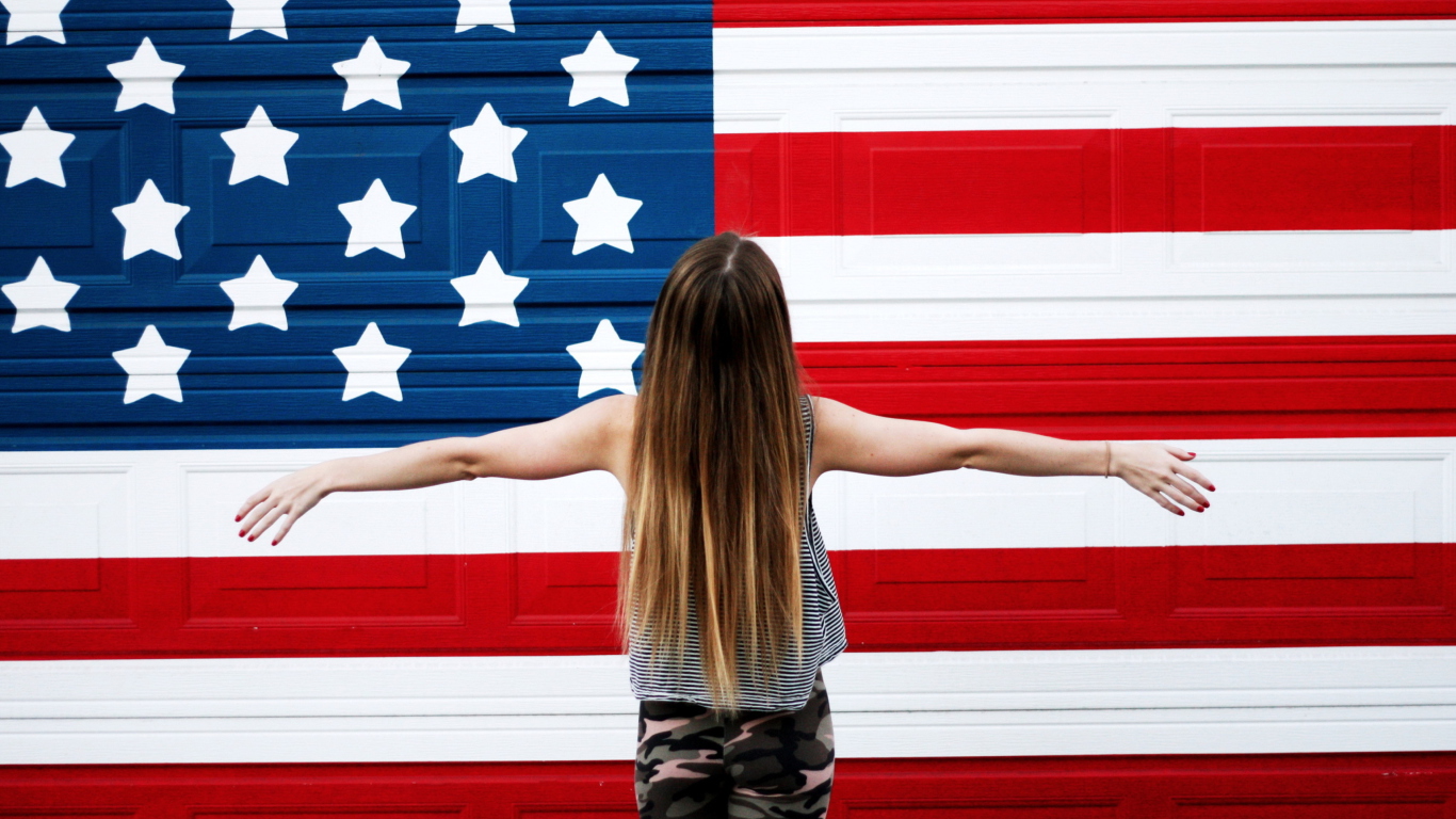 American Girl In Front Of USA Flag wallpaper 1366x768