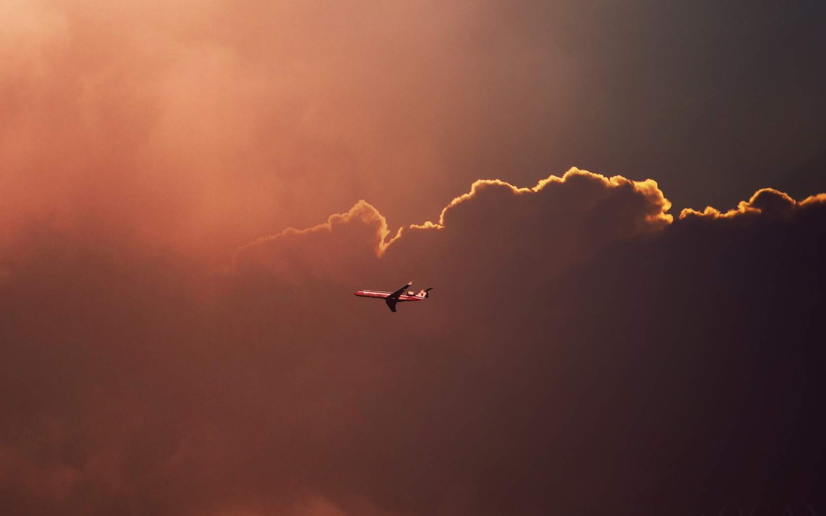 Обои Airplane In Red Sky Above Clouds 1680x1050