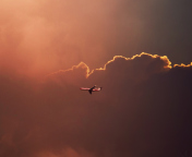 Fondo de pantalla Airplane In Red Sky Above Clouds 176x144