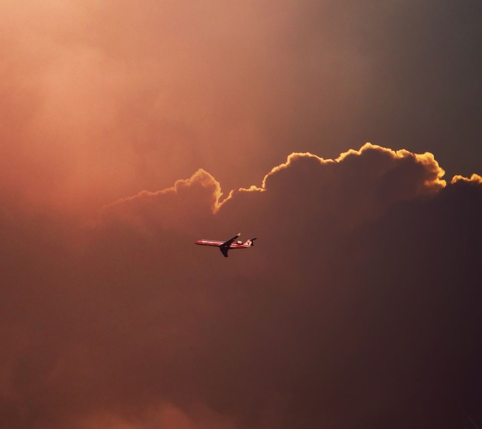 Airplane In Red Sky Above Clouds wallpaper 960x854