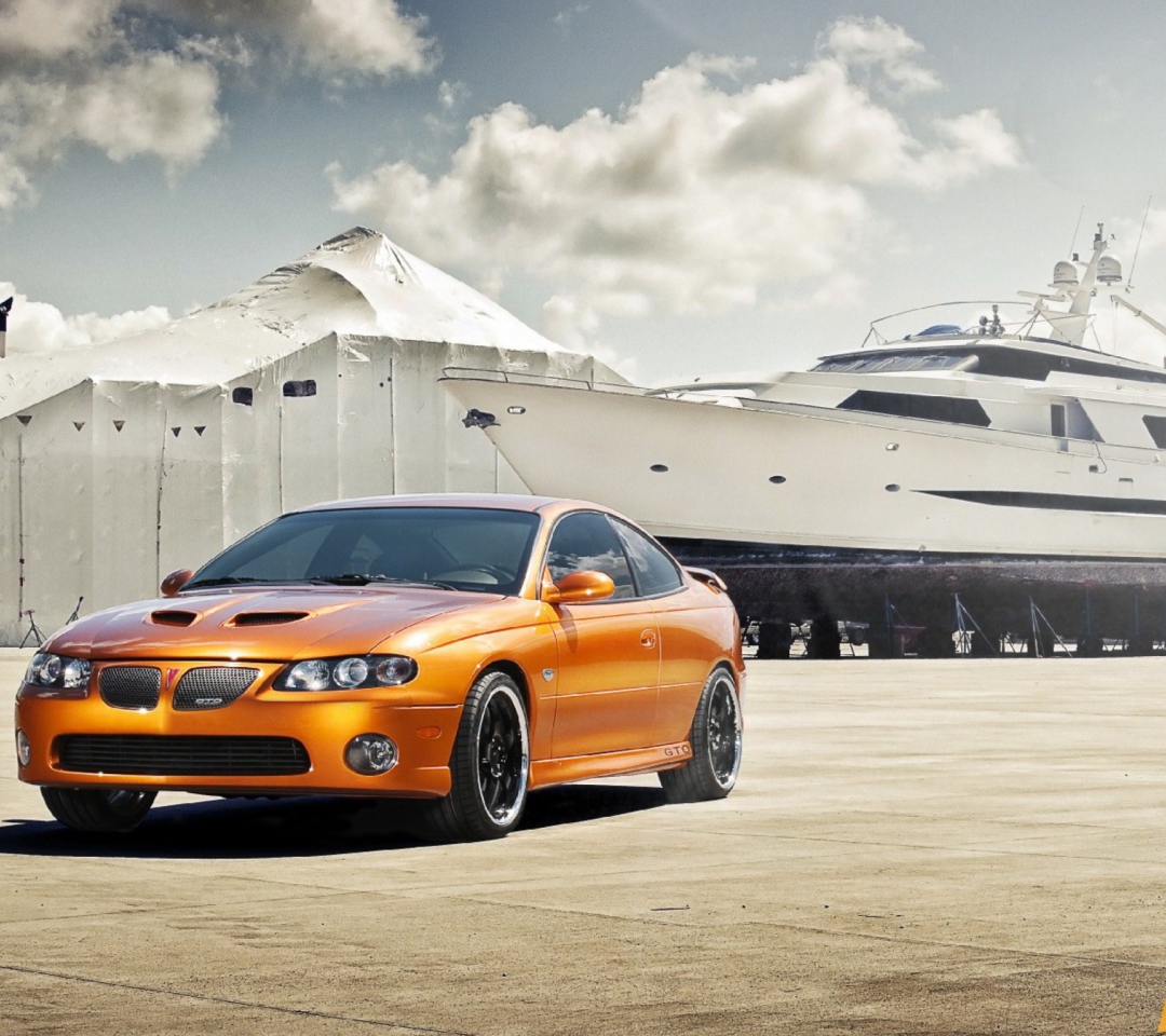 Orange Pontiac GTO In Port Ship wallpaper 1080x960