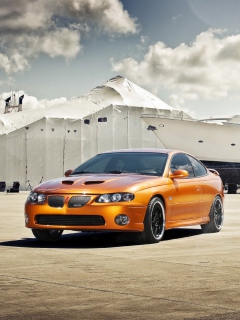 Orange Pontiac GTO In Port Ship wallpaper 240x320