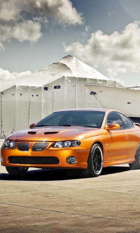 Orange Pontiac GTO In Port Ship wallpaper 480x800