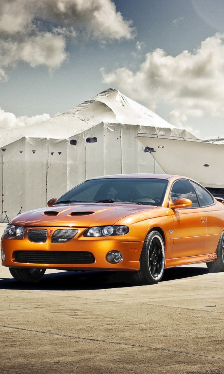 Sfondi Orange Pontiac GTO In Port Ship 768x1280