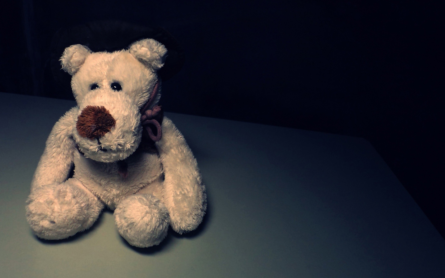 Обои Sad Teddy Bear Sitting Alone 1440x900