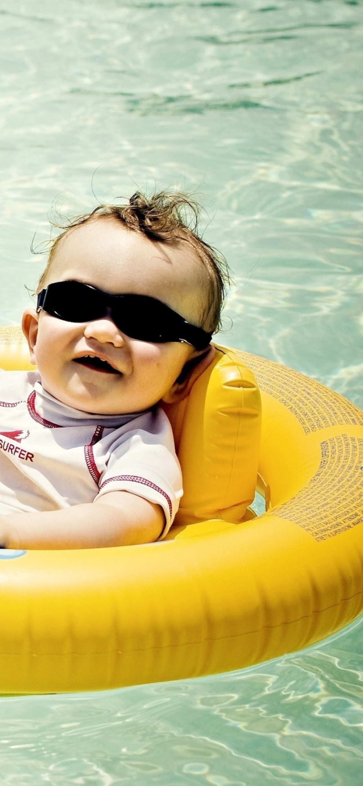 Cute Baby Boy Having Fun In Pool wallpaper 1170x2532
