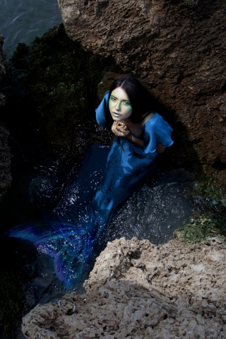 Blue Mermaid Hiding Behind Rocks wallpaper 320x480