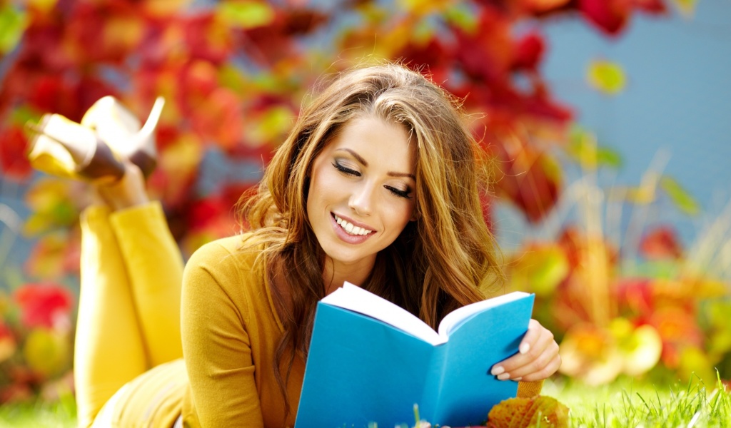 Girl Reading Book in Autumn Park wallpaper 1024x600