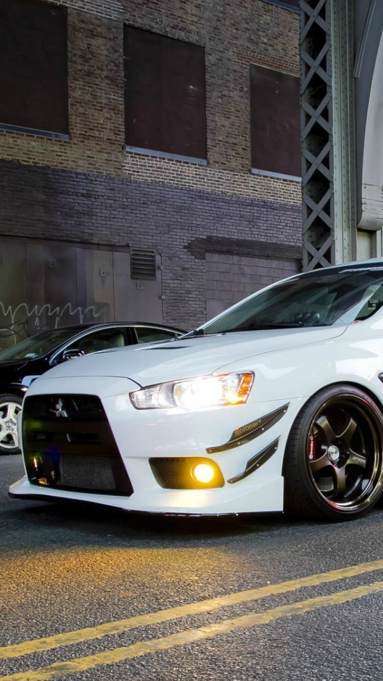 Street racing with Mitsubishi Lancer Evo X wallpaper 750x1334