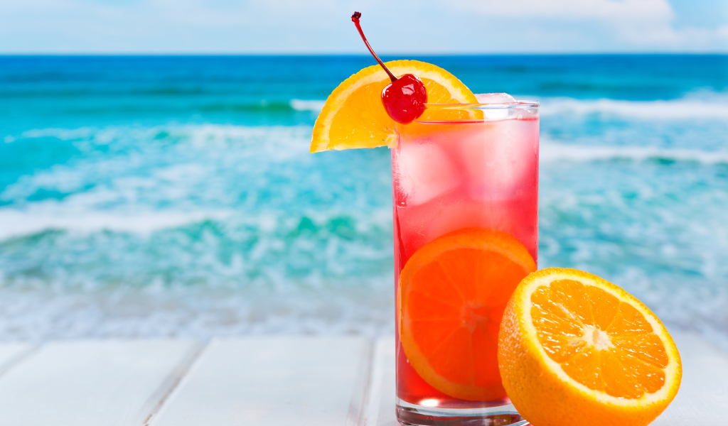 Tropical Paradise Cocktail With Cherry On Top wallpaper 1024x600