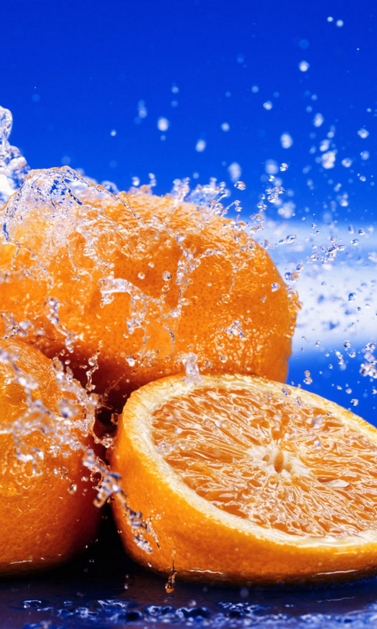 Juicy Oranges In Water Drops wallpaper 768x1280