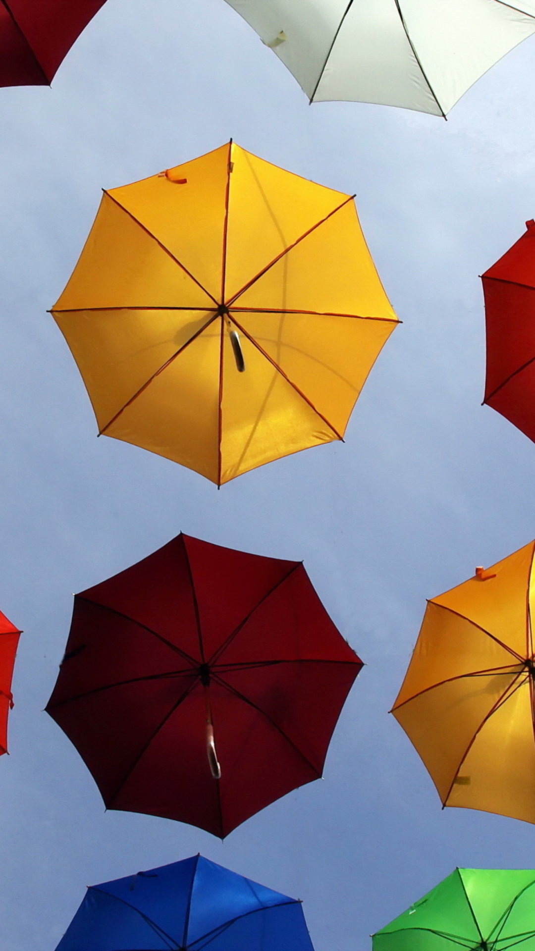 Sfondi Colorful Umbrellas In Blue Sky 1080x1920