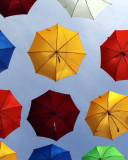 Fondo de pantalla Colorful Umbrellas In Blue Sky 128x160